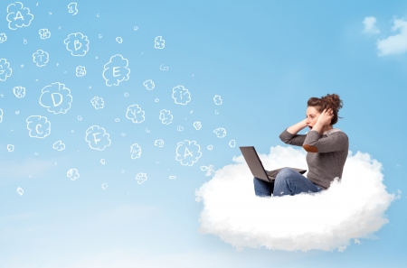 Pretty young woman sitting in cloud with laptop, letters conceptの写真素材