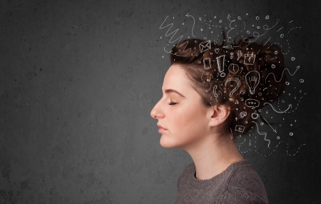 Young girl thinking with abstract icons on her headの写真素材