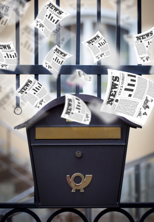 Post box with daily newspapers flying outの写真素材