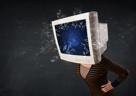 Computer monitor screen exploding on a young persons head conceptの写真素材