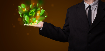 Young business man in suit presenting eco green leaf recycle energy conceptの写真素材