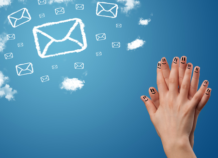 Happy cheerful smiley fingers looking at mail icons made out of cloudsの写真素材