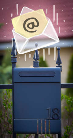 White envelope with email sign dropping into mailbox