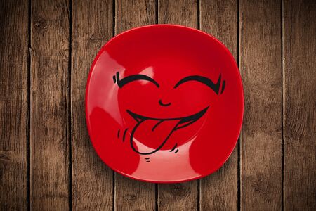 Happy smiley cartoon face on colorful dish plate and grungy backgroundの写真素材