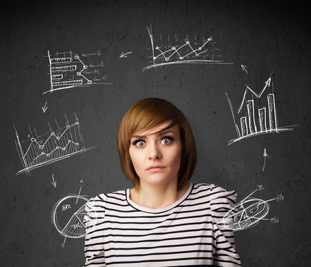 Thoughtful young woman with drawn charts circulating around her headの写真素材