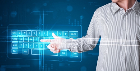 Young businessman pressing virtual type of keyboard