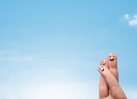 Happy cheerful smiley fingers looking at clear blue sky copyspaceの写真素材