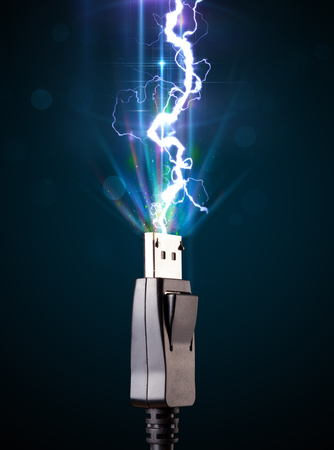 Electric cable close-up with glowing electricity lightningの写真素材