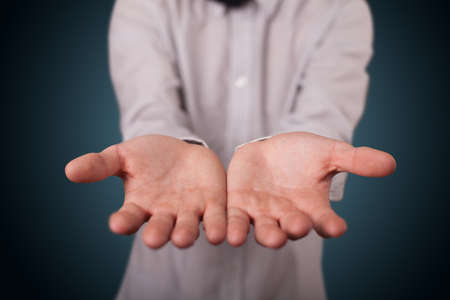 Handsome business man presenting with hand empty copy spaceの写真素材