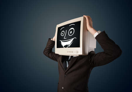 Happy businessman with a personal computer monitor head and a smiley face