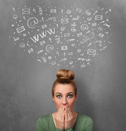 Pretty young woman gesturing with sketched social network icons above her headの写真素材
