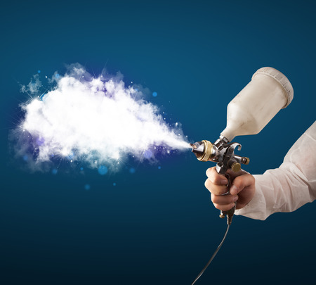 Painter with airbrush gun and white magical smoke conceptの写真素材