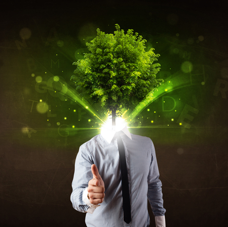 Man with green tree head concept on brown backgroundの写真素材