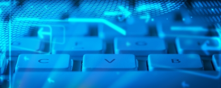 Computer keyboard with glowing cloud computing and multimedia icons