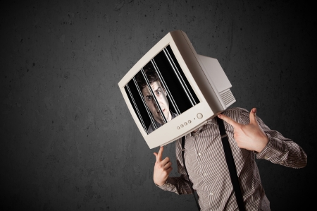 Business man with monitor screen on his head traped into a digital system conceptの写真素材