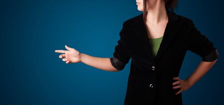Young woman pressing imaginary buttonの写真素材