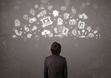 Business man looking at modern icons and symbols conceptの写真素材