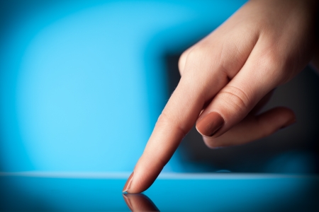 Hand touching tablet pc with copy spaceの写真素材