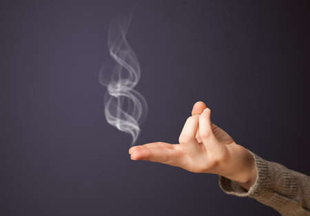 Gun shaped woman hand with smokeの写真素材