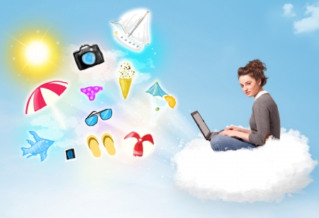 Pretty young woman sitting in cloud with laptop, summer travel conceptの写真素材