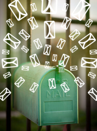 Mailbox with letter icons exploding on glowing green backgroundの写真素材