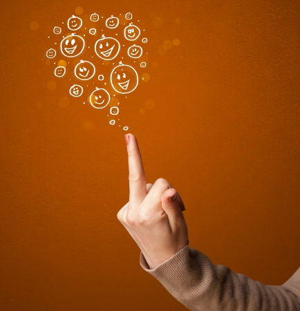 Group of happy hand drawed smiley faces coming out of gun shaped handsの写真素材