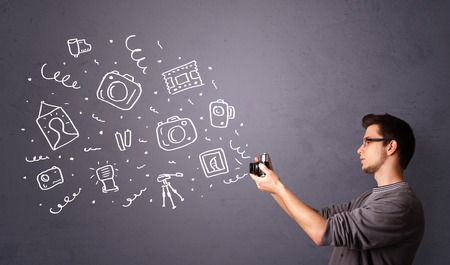 Attractive young photographer shooting photography iconsの写真素材