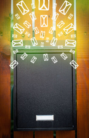 Mailbox with letter icons exploding on glowing green backgroundの写真素材
