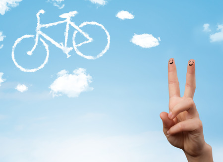 Happy cheerful smiley fingers looking at a bicycle shapeed cloudの写真素材