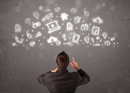 Business man looking at modern icons and symbols conceptの写真素材
