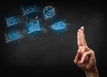 Happy finger smileys faces on hand with blue chart icons and symbolsの写真素材