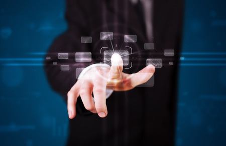 Young businessman pressing high tech type of modern buttons の写真素材