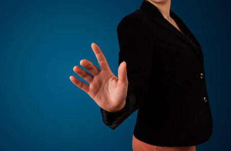 Young woman pressing imaginary buttonの写真素材