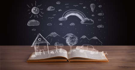 Open book with hand drawn landscape on wooden deck