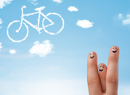 Happy cheerful smiley fingers looking at a bicycle shapeed cloudの写真素材