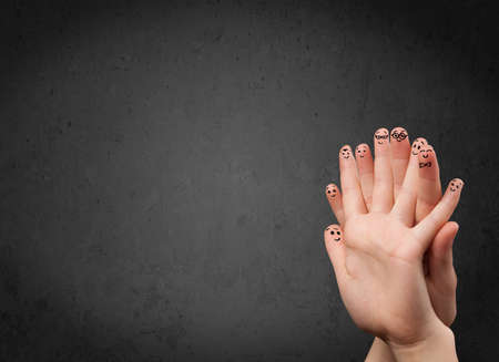 Happy finger smileys faces on hand with empty copy space dark backgroundの写真素材