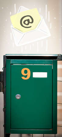 White envelope with email sign dropping into mailbox