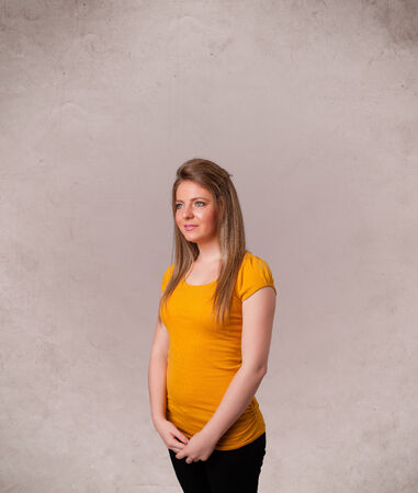 Portrait of a young cute girl with empty copy space on grungy backgroundの写真素材