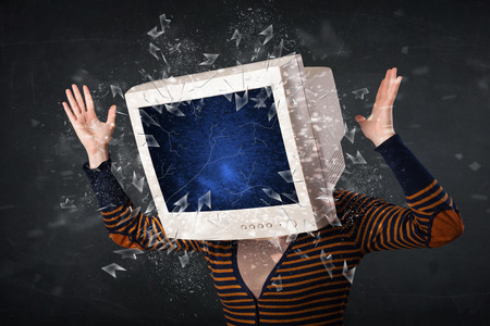 Computer monitor screen exploding on a young persons head conceptの写真素材