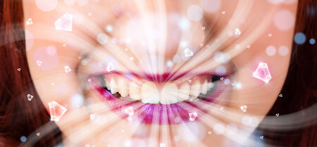 Beautiful girl mouth breathing abstract white lights and crystals close upの写真素材
