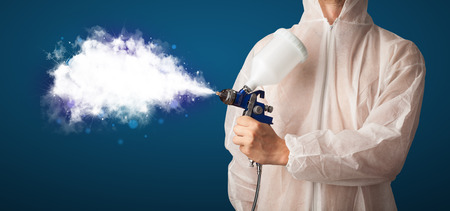 Painter with airbrush gun and white magical smoke conceptの写真素材