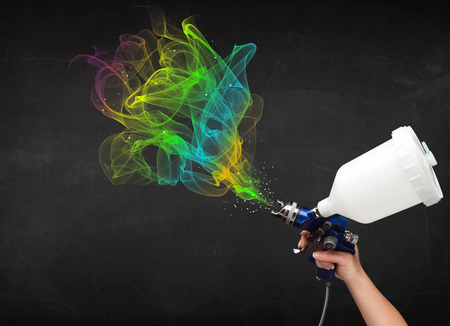 Painter working with airbrush and paints colorful paint conceptの写真素材