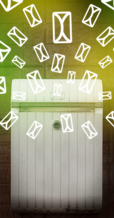 Mailbox with letter icons exploding on glowing green backgroundの写真素材