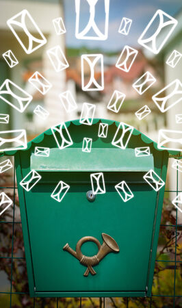 Mailbox with letter icons exploding on glowing green backgroundの写真素材