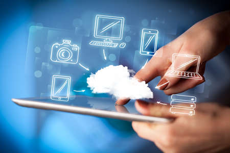 Hand touching tablet pc, mobile cloud concept