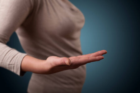 Young girl presenting with hand empty copy spaceの写真素材