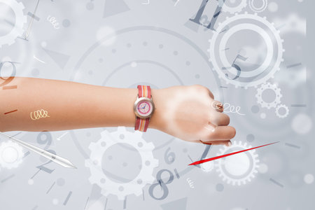 Hand with watch and numbers comming out on the sideの写真素材