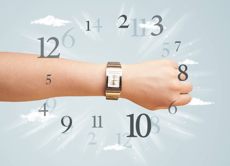 Hand with watch and numbers comming out on the sideの写真素材