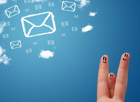 Happy cheerful smiley fingers looking at mail icons made out of cloudsの写真素材