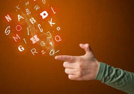 Glowing letters coming out of gun shaped handsの写真素材